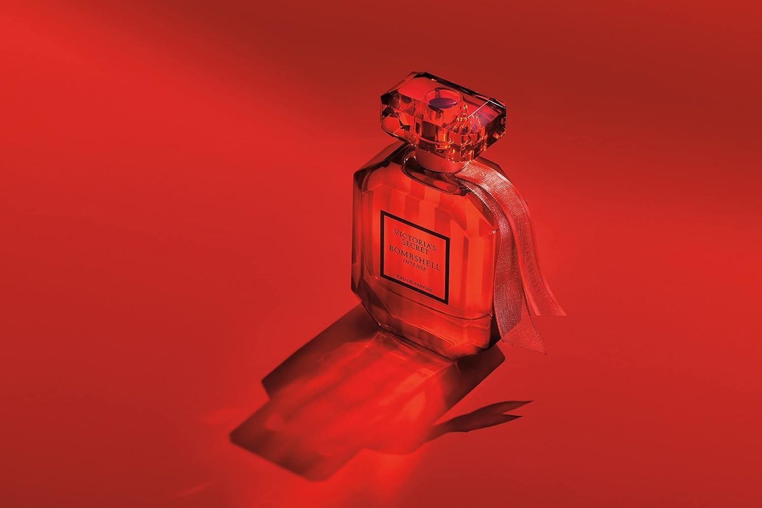 Red perfume bottle with a red background